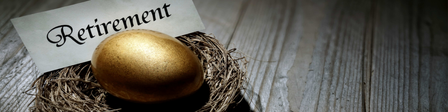 Golden egg in nest on wooden floorboards