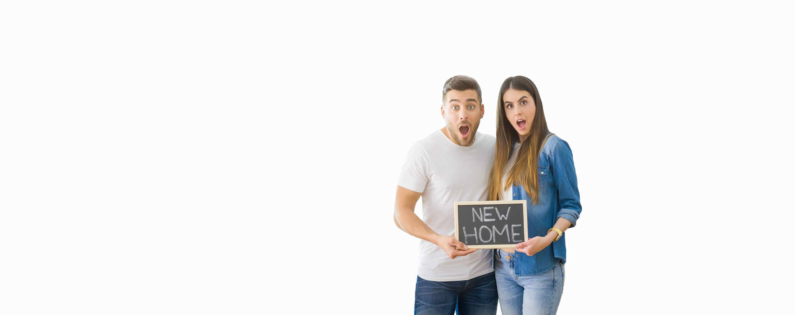 Young couple with new home sign